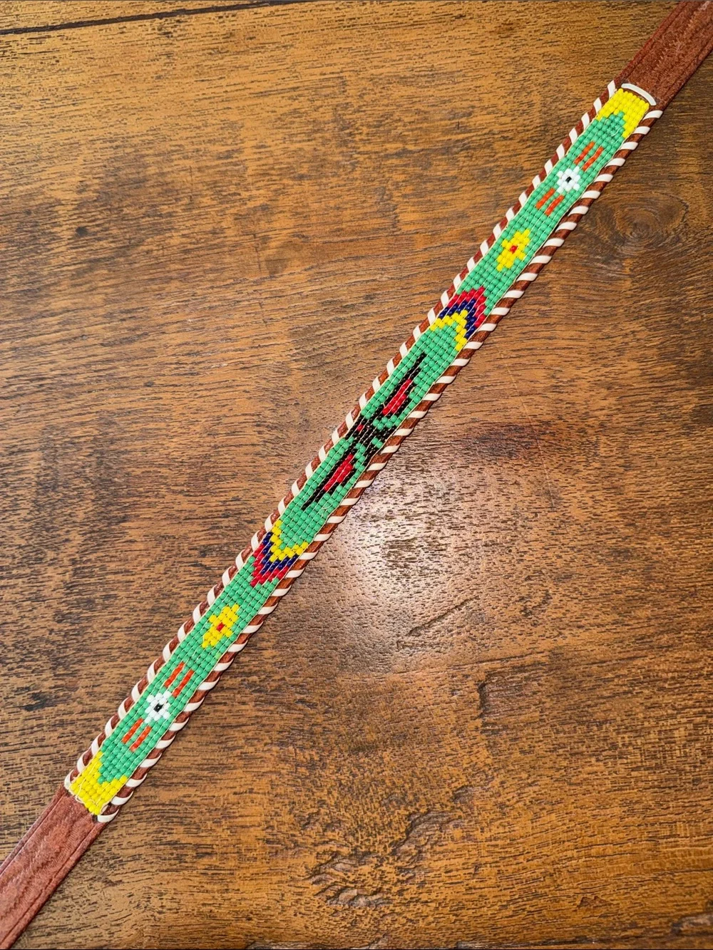 Child’s souvenir beaded belt with brown leather